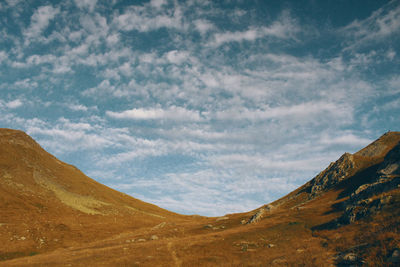 Scenic view of mountains against cloudy sky