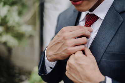 Midsection of businessman wearing suit outdoors