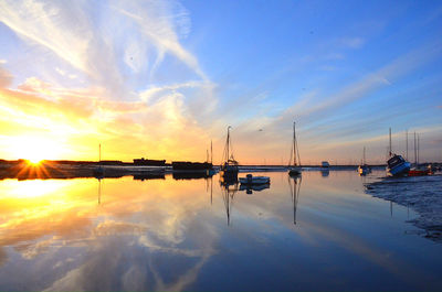 Reflection of clouds in sea at sunset