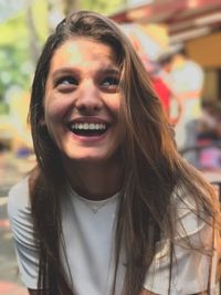 Close-up young woman laughing while looking away