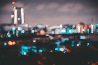 Defocused image of illuminated city at night