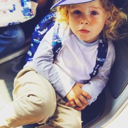 High angle portrait of cute baby boy sitting on chair