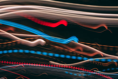 Low angle view of light trails in city