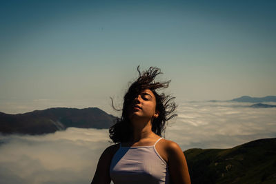 Portrait of girl against mountains against sky