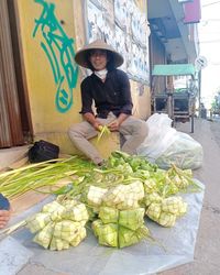 High angle view of man with vegetables for sale at market stall