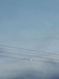 Low angle view of birds moon and sky