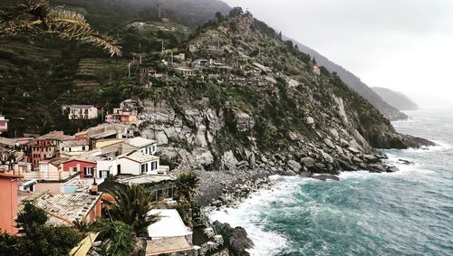 Scenic view of sea by buildings in town