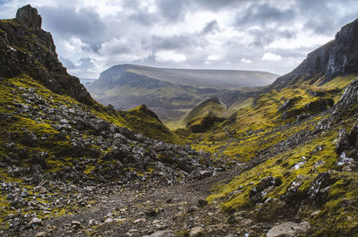 Scenic view of mountains against cloudy sky