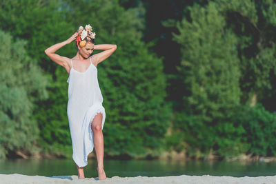 Midsection of woman standing by plants