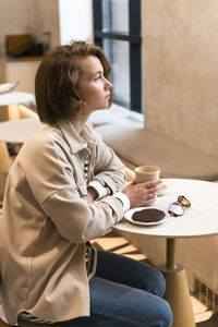 Side view of girl playing with cookies at home