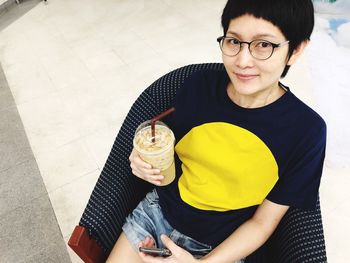 Portrait of smiling young woman holding ice cream