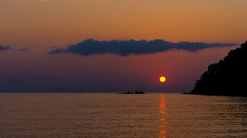 Scenic view of sea against romantic sky at sunset