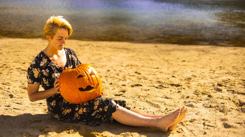 Young woman playing violin at beach