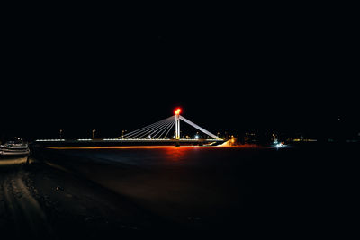 Illuminated suspension bridge at night