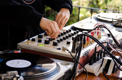 Midsection of man using sound mixer