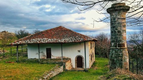 Abandoned built structure on landscape against sky