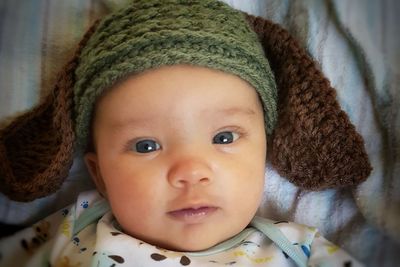 Directly above portrait of baby boy lying on bed