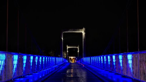 Illuminated bridge at night