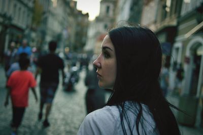 Woman looking away in city