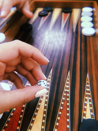 Cropped hand of woman holding dice