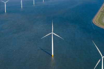 High angle view of wind turbines in sea