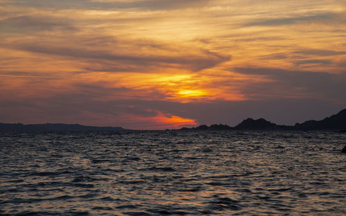 Scenic view of sea against romantic sky at sunset