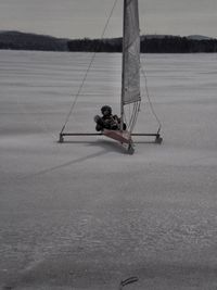 Man in sea against sky