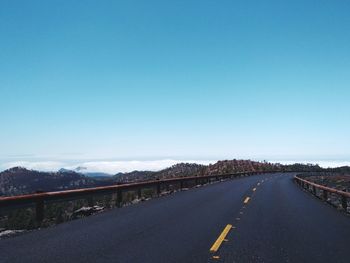 Road against clear blue sky