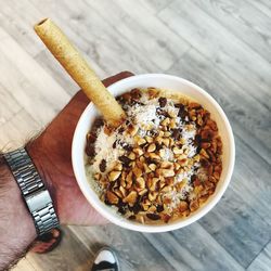 High angle view of person holding bread on table