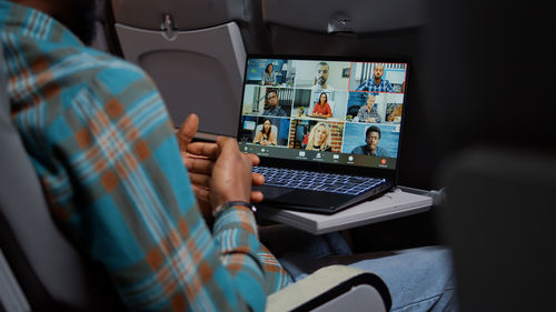 Midsection of woman using laptop