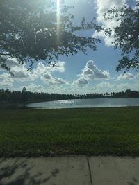 Scenic view of grassy field against sky