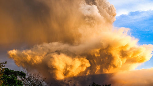 Smoke emitting from volcanic mountain against sky 