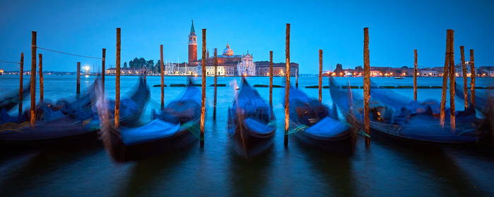 Gondolas moored at lakeshore