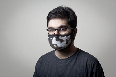 Close-up portrait of young man against white background