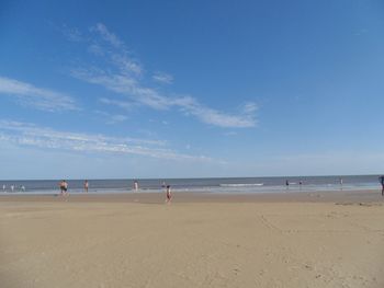 Scenic view of beach against blue sky