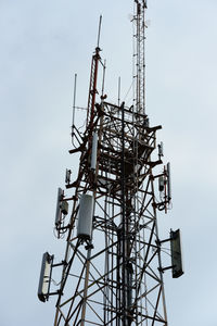 Low angle view of communications tower against sky