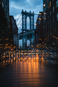 Illuminated city street and buildings at dusk