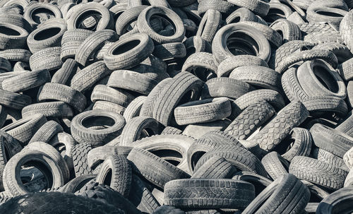 Landfill of old car tires torn spoiled abandoned.