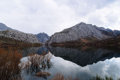 Scenic view of lake and mountains against sky