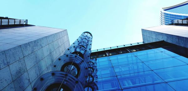 Low angle view of modern building against clear blue sky