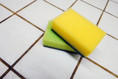 Close-up of sponge scrub on tiled floor