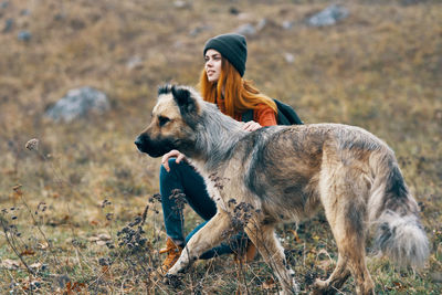 Portrait of a dog on woman during autumn