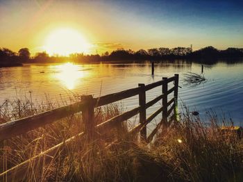 Scenic view of lake against sky during sunset