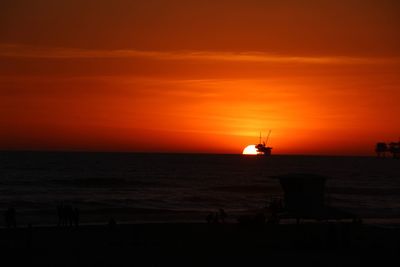 Scenic view of sea against orange sky