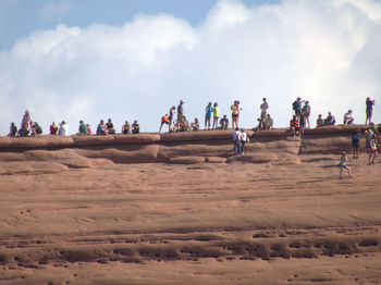 People on landscape against sky