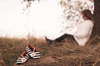 Midsection of man sitting on field
