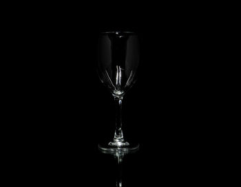 Close-up of wineglass against black background