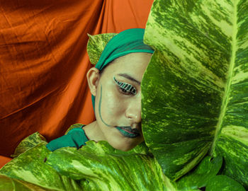 Close-up portrait of a woman portraying the stage of pupa of metamorphosis of a butterfly