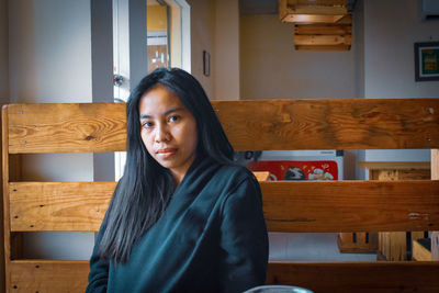 Portrait of young woman on table