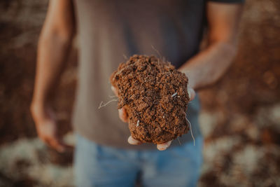 Close-up of man holding leaf